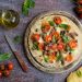 piadipizza con pomodorini mozzarella olive capperi e acciughe